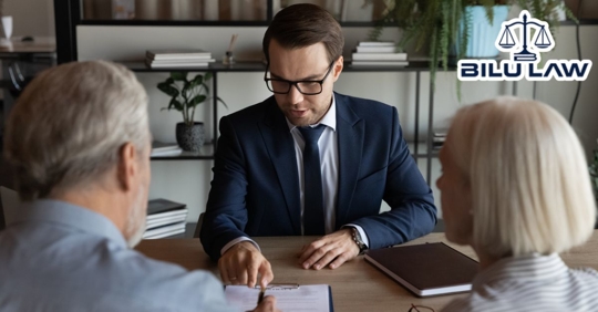 Attorney counsel advising couple with paperwork contract
